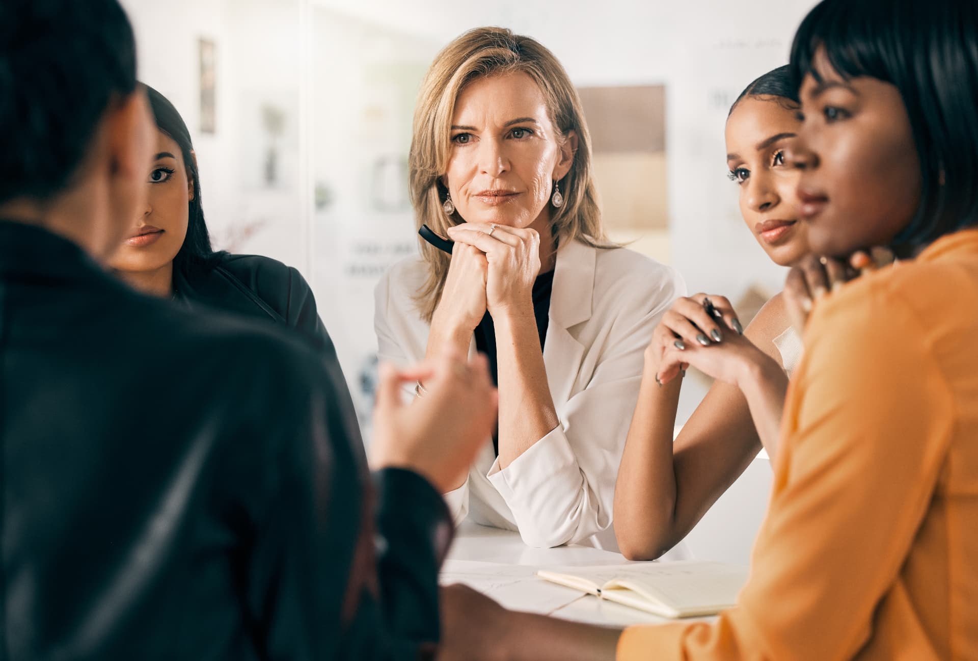 A group of professional women discussing around a table